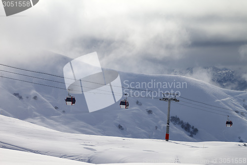 Image of Gondola lifts and off-piste slope in mist