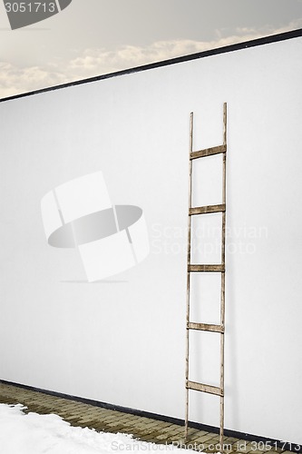 Image of white wall with a wooden ladder