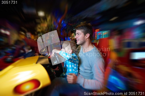 Image of father and son playing game in playground