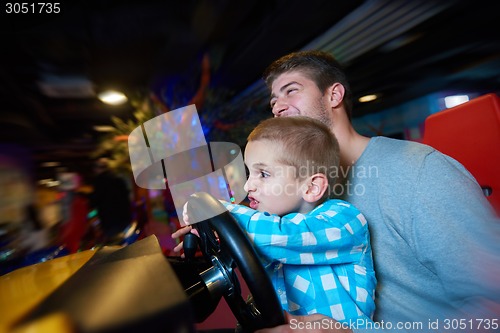 Image of father and son playing game in playground