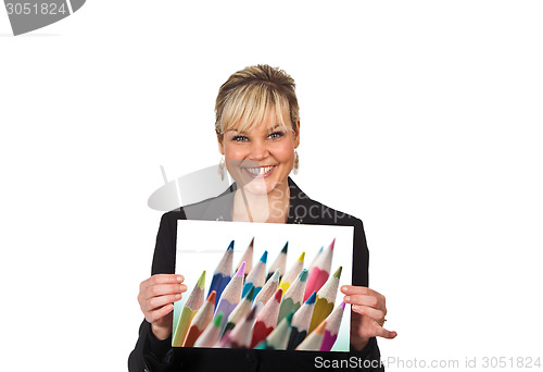 Image of Studio portrait of a cute blond girl holding a piece of paper