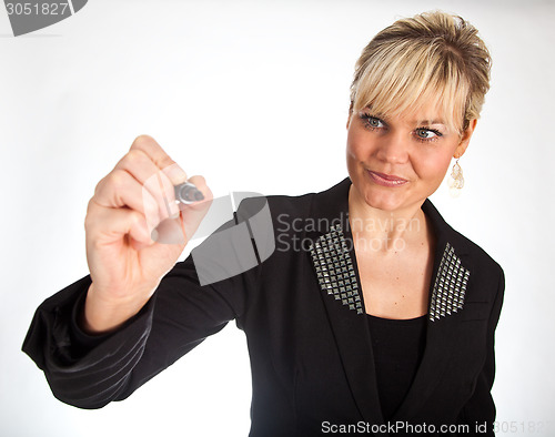 Image of Studio portrait of a cute blond girl writing on a transparent wa