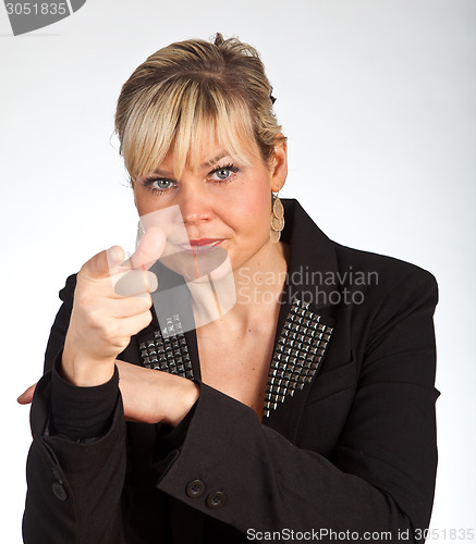 Image of Studio portrait of a cute blond girl pointing with her finger