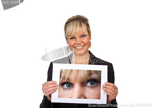 Image of Studio portrait of a cute blond girl holding a piece of paper