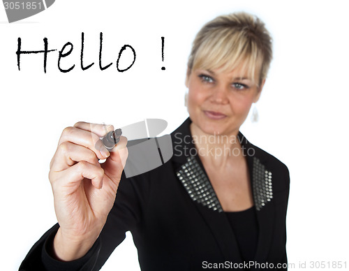 Image of Studio portrait of a cute blond girl writing on a transparent wa