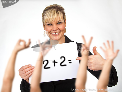 Image of Studio portrait of a cute blond girl holding a piece of paper