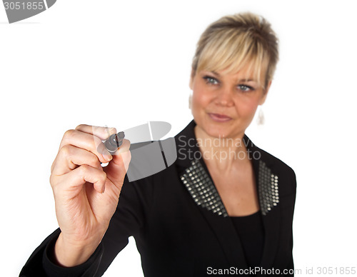 Image of Studio portrait of a cute blond girl writing on a transparent wa