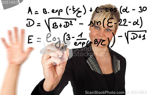 Image of Studio portrait of a cute blond girl writing on a transparent wa