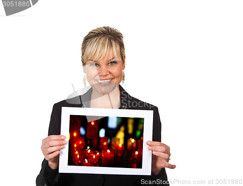 Image of Studio portrait of a cute blond girl holding a piece of paper