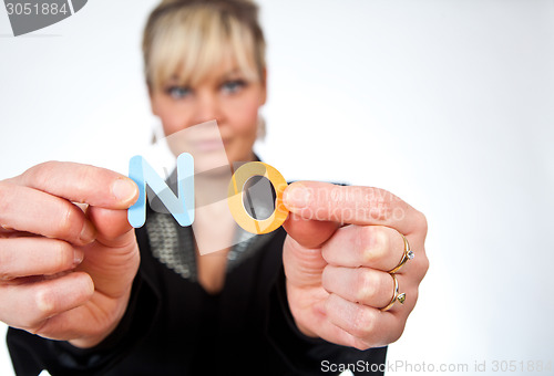 Image of Studio portrait of a cute blond girl holding two letters forming