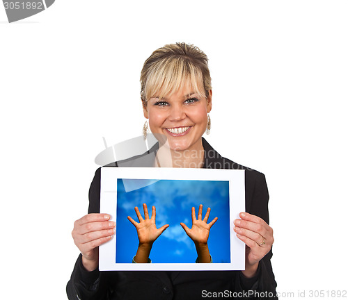 Image of Studio portrait of a cute blond girl holding a piece of paper