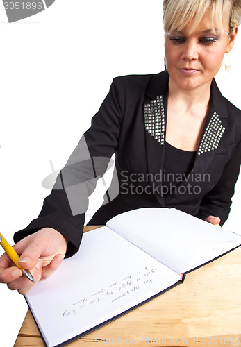 Image of Studio portrait of a cute blond girl writing