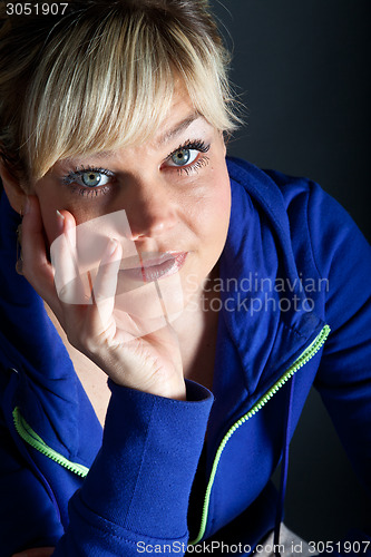Image of Studio portrait of a cute blond girl bored with heads in hands