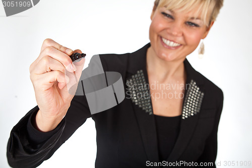 Image of Studio portrait of a cute blond girl writing on a transparent wa