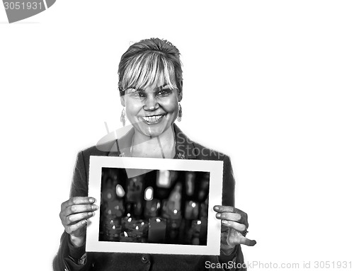 Image of Studio portrait of a cute blond girl holding a piece of paper