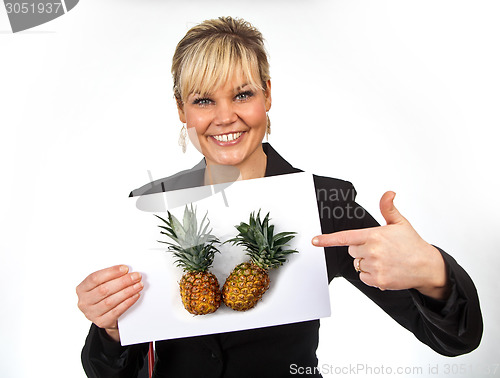 Image of Studio portrait of a cute blond girl holding a piece of paper