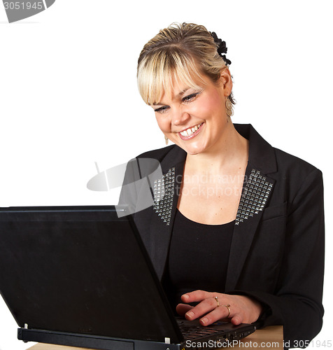 Image of Studio portrait of a cute blond girl with a computer