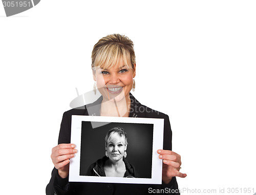 Image of Studio portrait of a cute blond girl holding a piece of paper