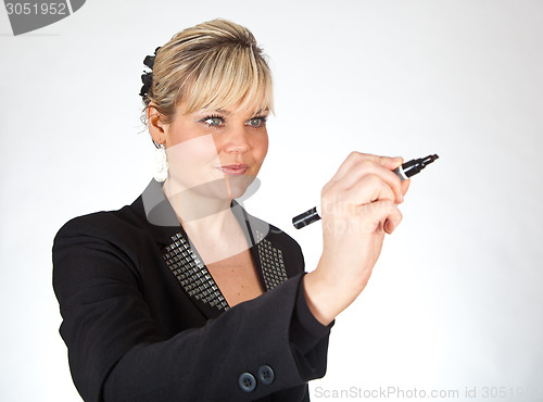 Image of Studio portrait of a cute blond girl writing on a transparent wa