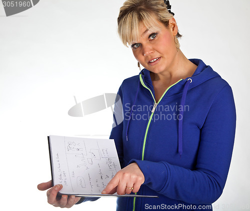Image of Studio portrait of a cute blond girl reading in a book