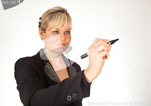 Image of Studio portrait of a cute blond girl writing on a transparent wa