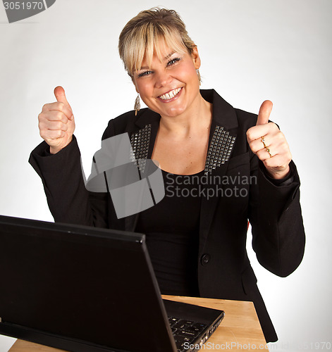 Image of Studio portrait of a cute blond girl with a computer hands up