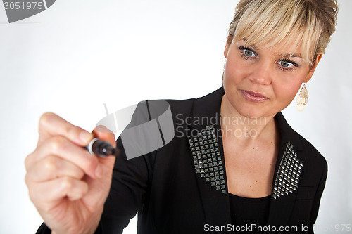 Image of Studio portrait of a cute blond girl writing on a transparent wa