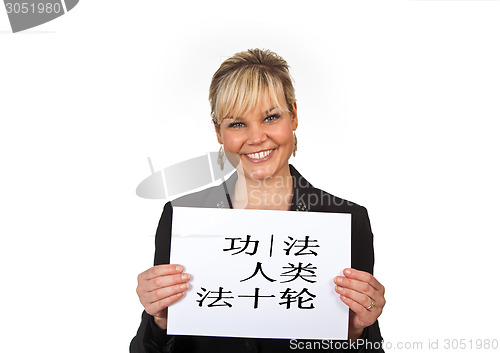 Image of Studio portrait of a cute blond girl holding a piece of paper