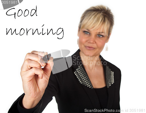 Image of Studio portrait of a cute blond girl writing on a transparent wa