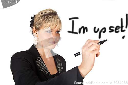 Image of Studio portrait of a cute blond girl writing on a transparent wa