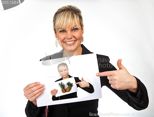 Image of Studio portrait of a cute blond girl holding a piece of paper