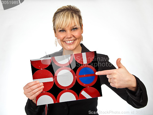 Image of Studio portrait of a cute blond girl holding a piece of paper