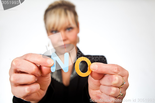 Image of Studio portrait of a cute blond girl holding two letters forming