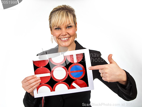 Image of Studio portrait of a cute blond girl holding a piece of paper