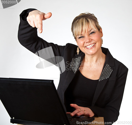 Image of Studio portrait of a cute blond girl with a computer hands up