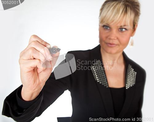 Image of Studio portrait of a cute blond girl writing on a transparent wa