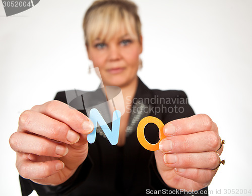 Image of Studio portrait of a cute blond girl holding two letters forming