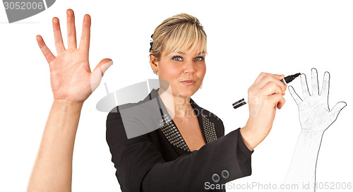 Image of Studio portrait of a cute blond girl writing on a transparent wa