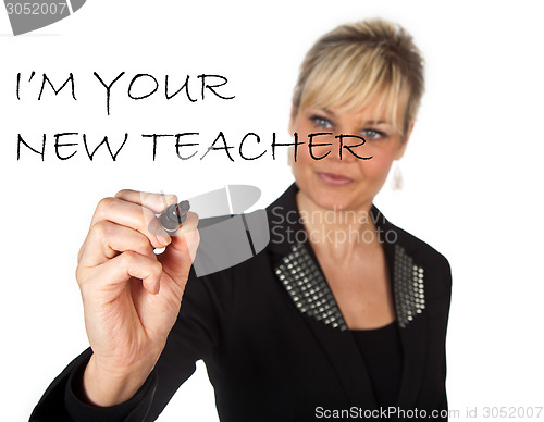 Image of Studio portrait of a cute blond girl writing on a transparent wa