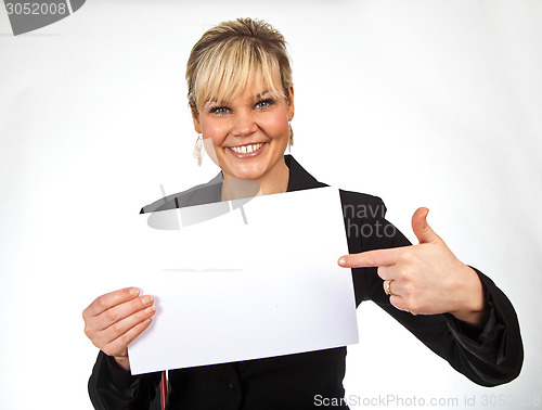 Image of Studio portrait of a cute blond girl holding a piece of paper