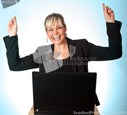 Image of Studio portrait of a cute blond girl with a computer hands up