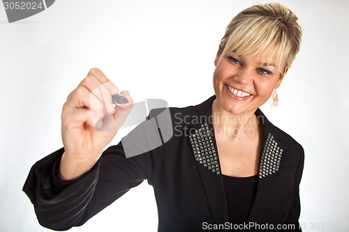 Image of Studio portrait of a cute blond girl writing on a transparent wa