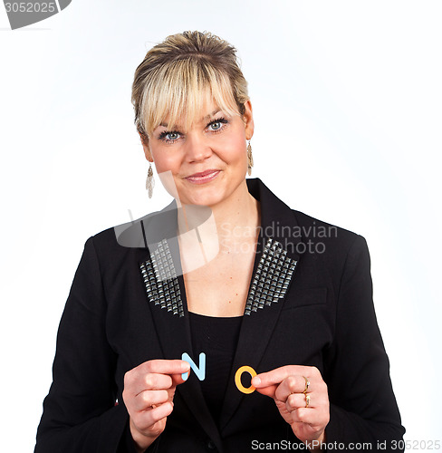 Image of Studio portrait of a cute blond girl holding two letters forming