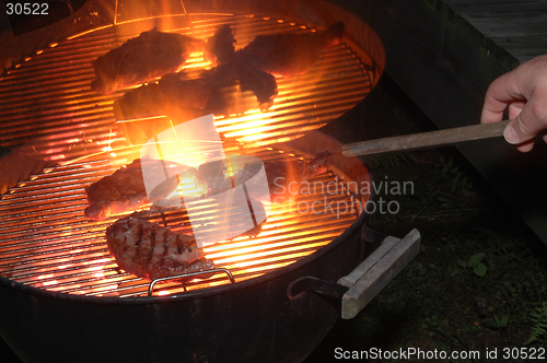 Image of steaks grilling