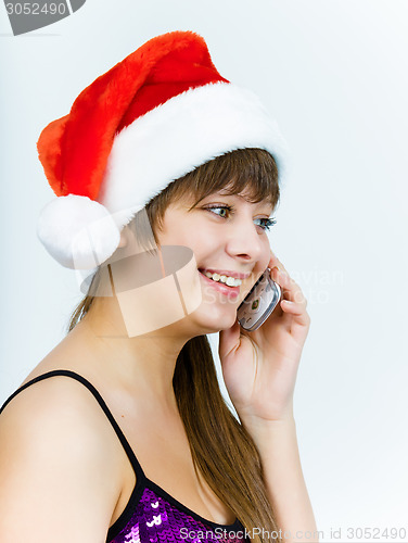 Image of young woman in santa hat talking on the phone