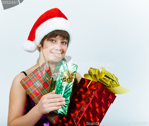 Image of young woman in santa hat with gift box