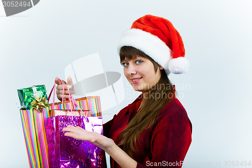 Image of young woman in santa hat with holiday shopping