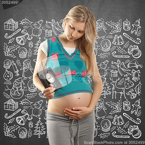 Image of Pregnant Woman Looking For Christmas Gifts