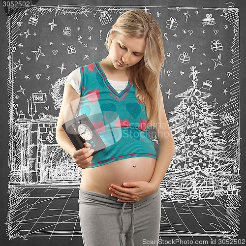 Image of Pregnant Woman Looking For Christmas Gifts