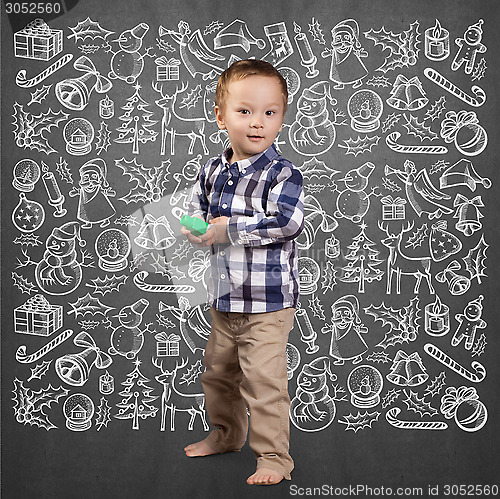 Image of Little Boy Looking For Christmas Gifts
